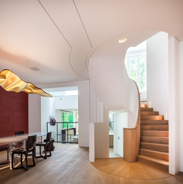 Photograph showing the dining areas and the sculptural staircase, 05 of 27.