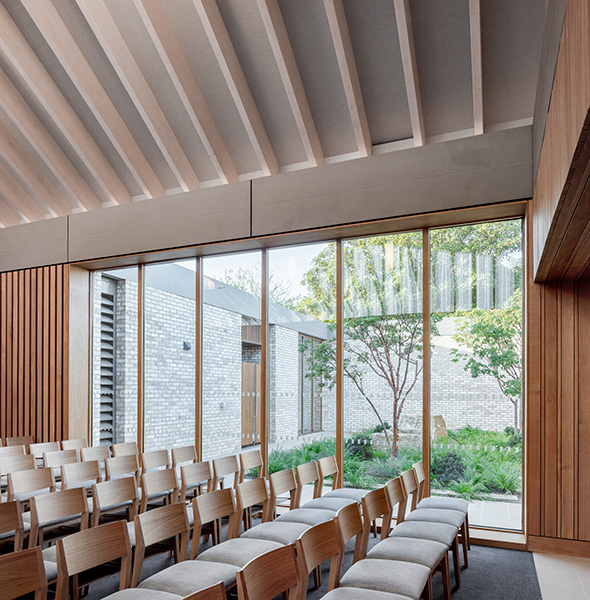 Chapel features extensive glazing creating connections to the private courtyards, 12 of 21.