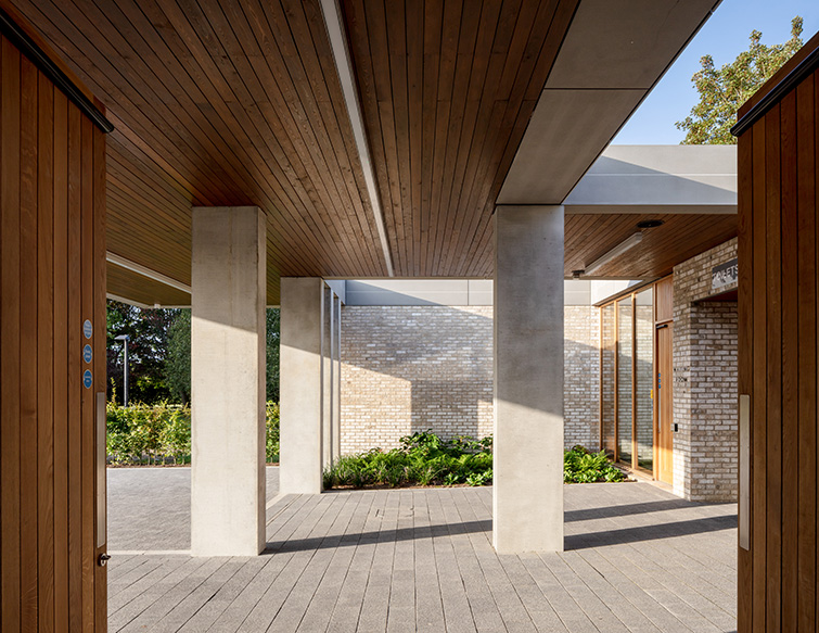 Entrance area with timber soffit and beautful pre-cast structural elements, 15 of 21.