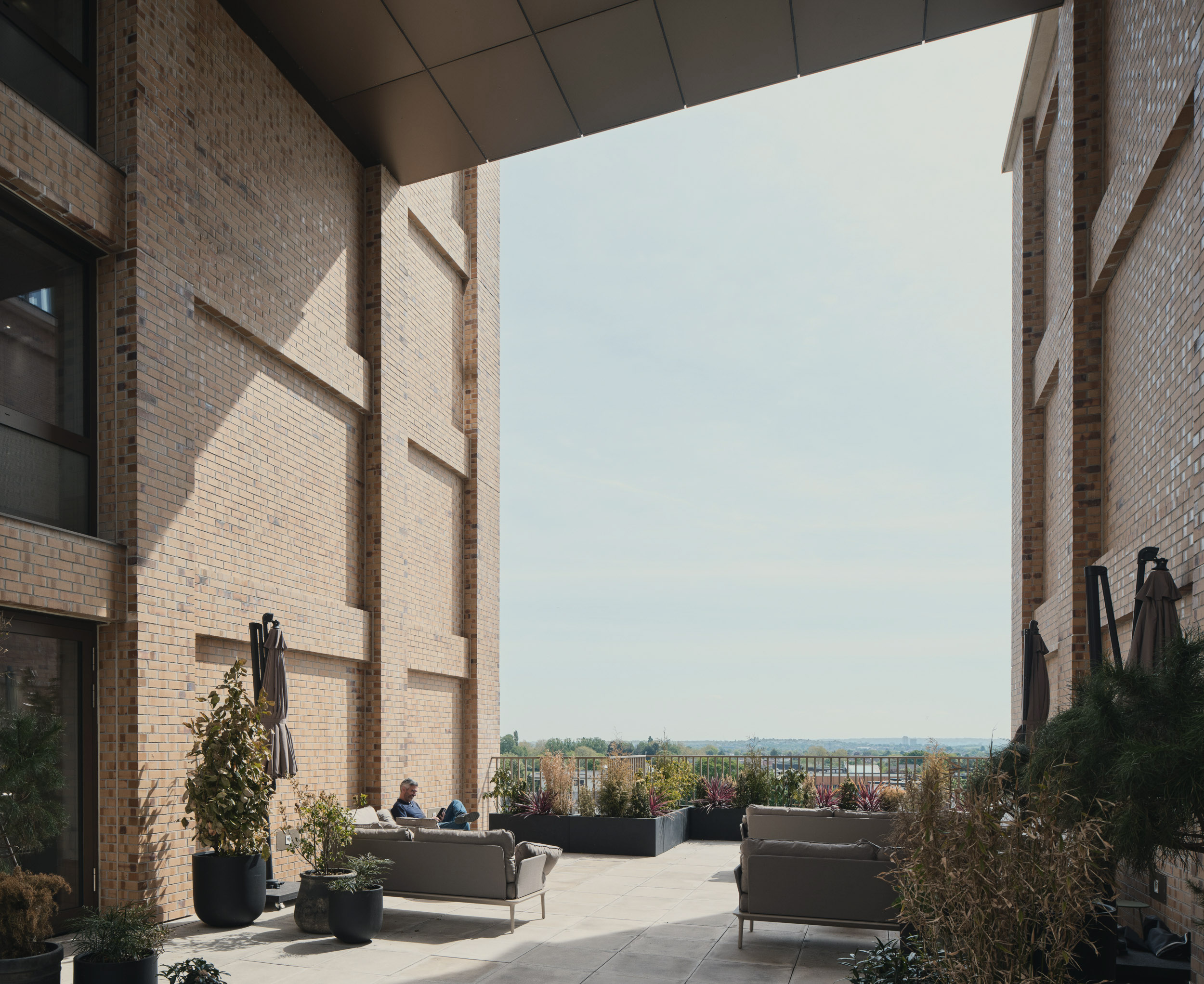 Exterior terrace photo showing seating and planting
